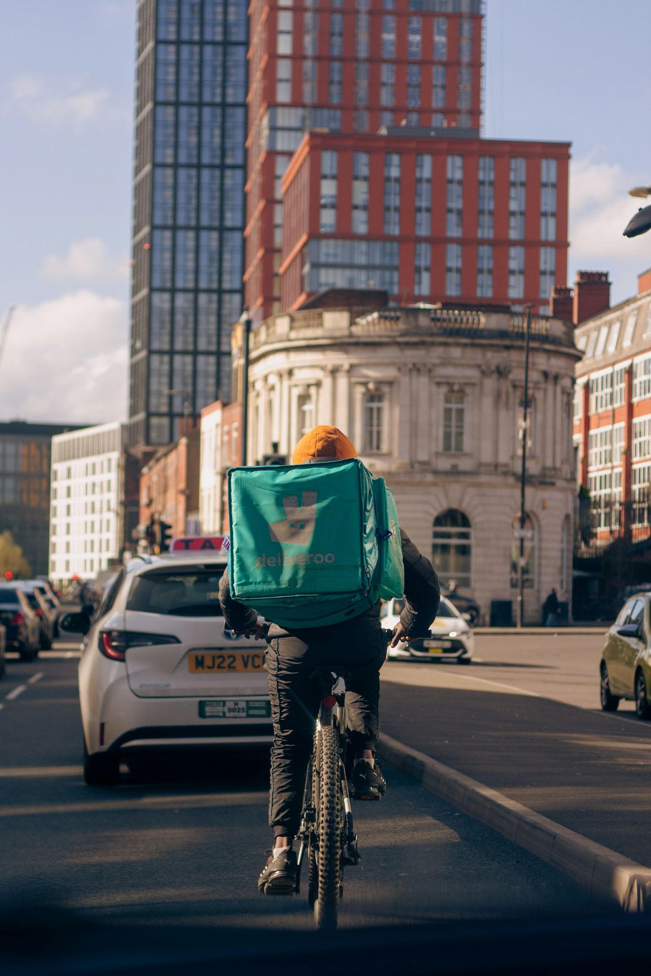 a person riding a bike down a city street